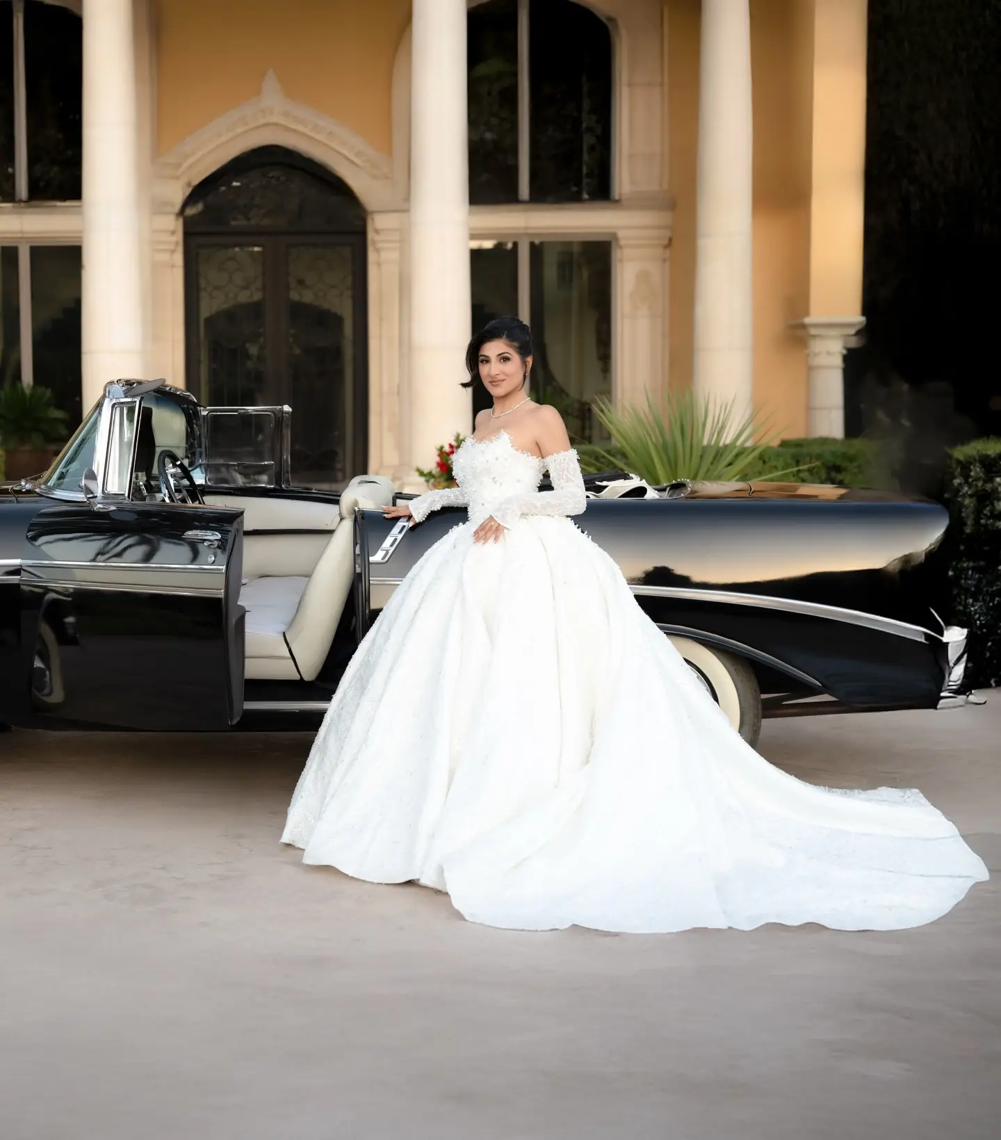 A bride by a vintage car at Bally Keal Estate