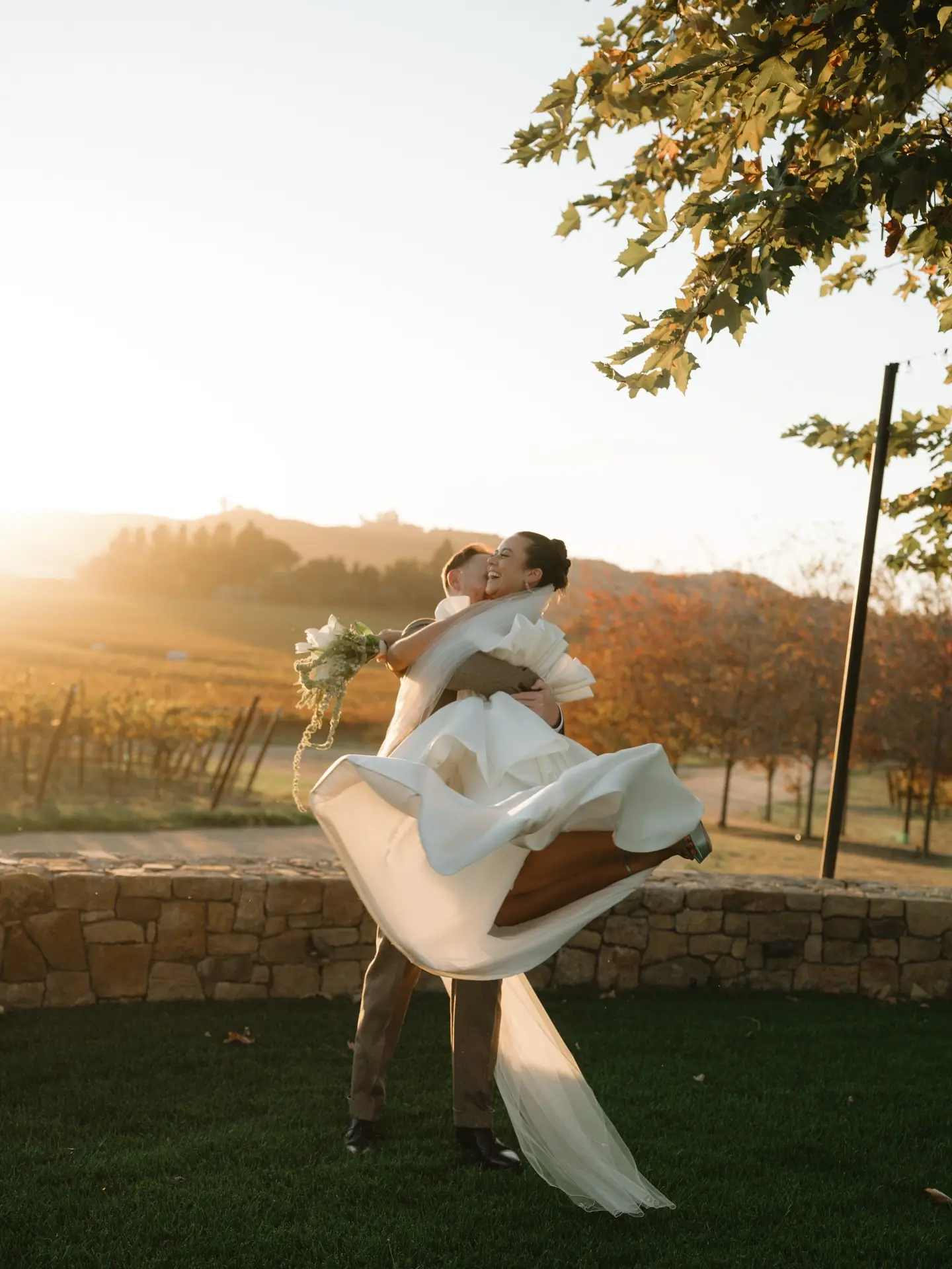 A couple in the vineyard at sunset at Cavalli Estates