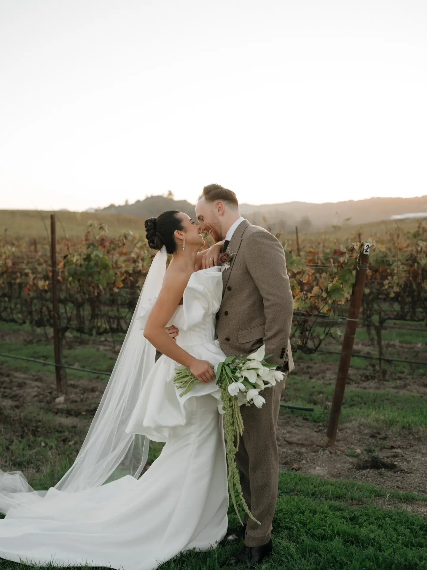 A couple among the vineyard rows at Cavalli Estates
