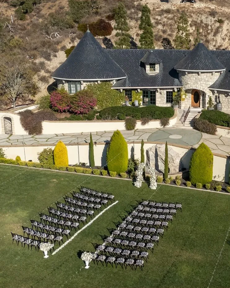 An aerial view of Chateau Noland, its ceremony lawn set with chairs below the stone chateau