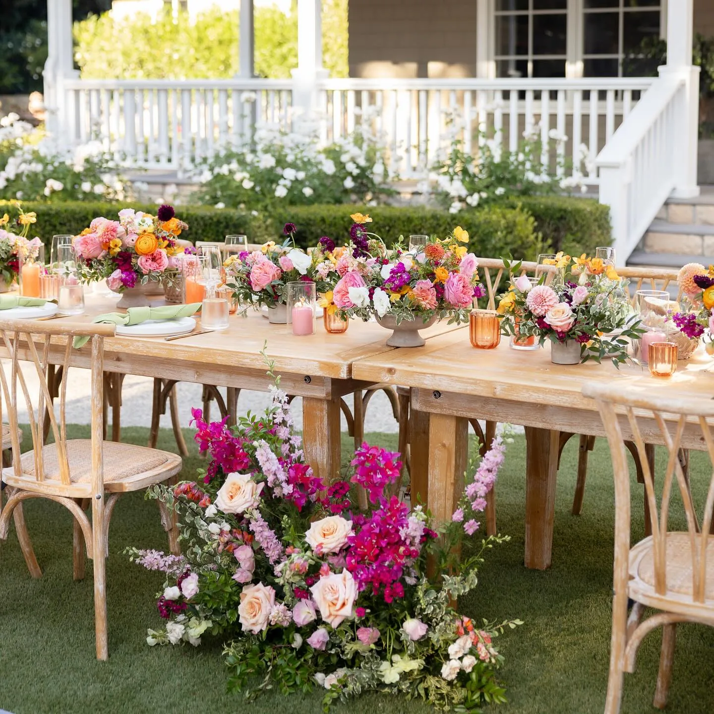 Wildflower-strewn banquet table under string lights