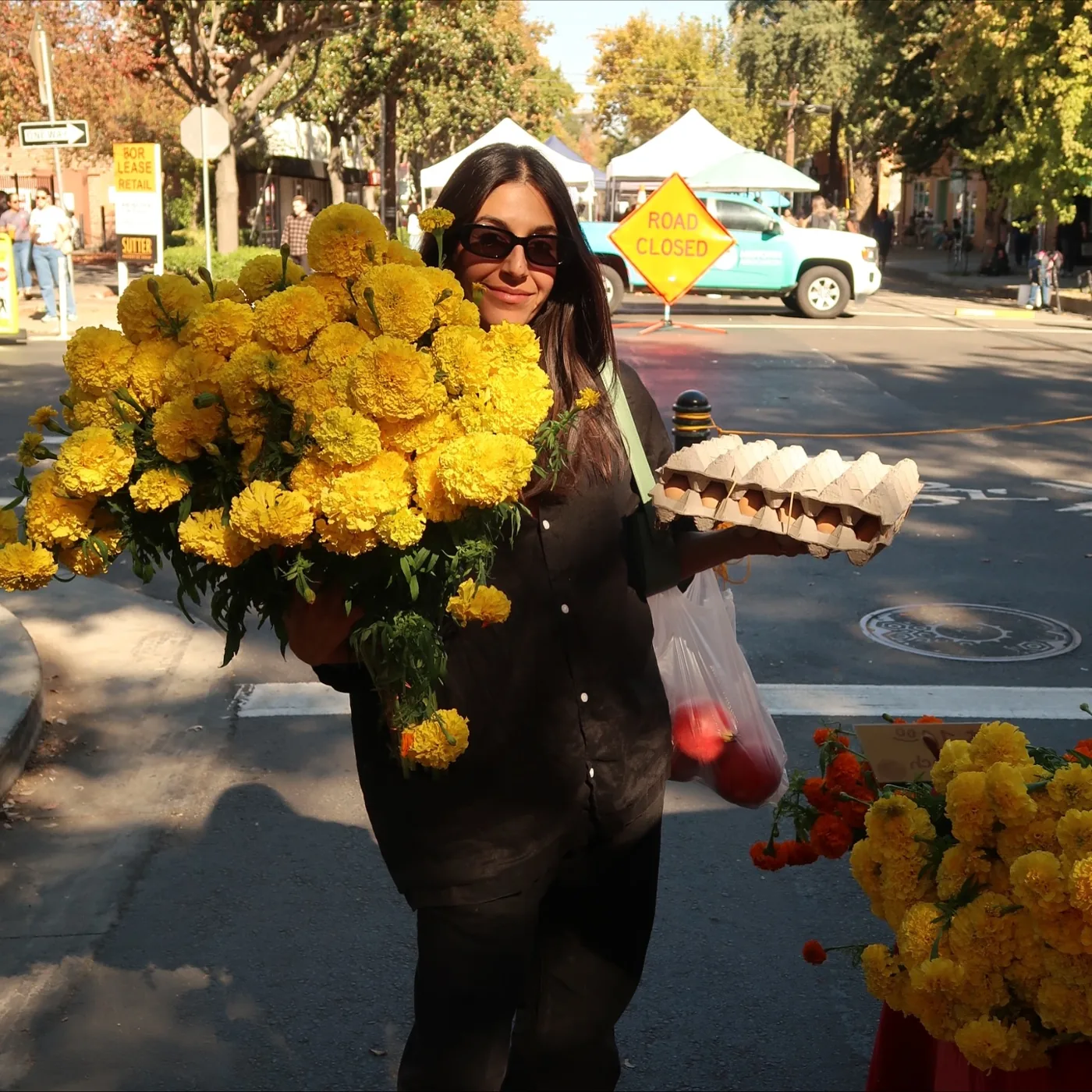 Golzar sourcing fresh flowers at the farmers market