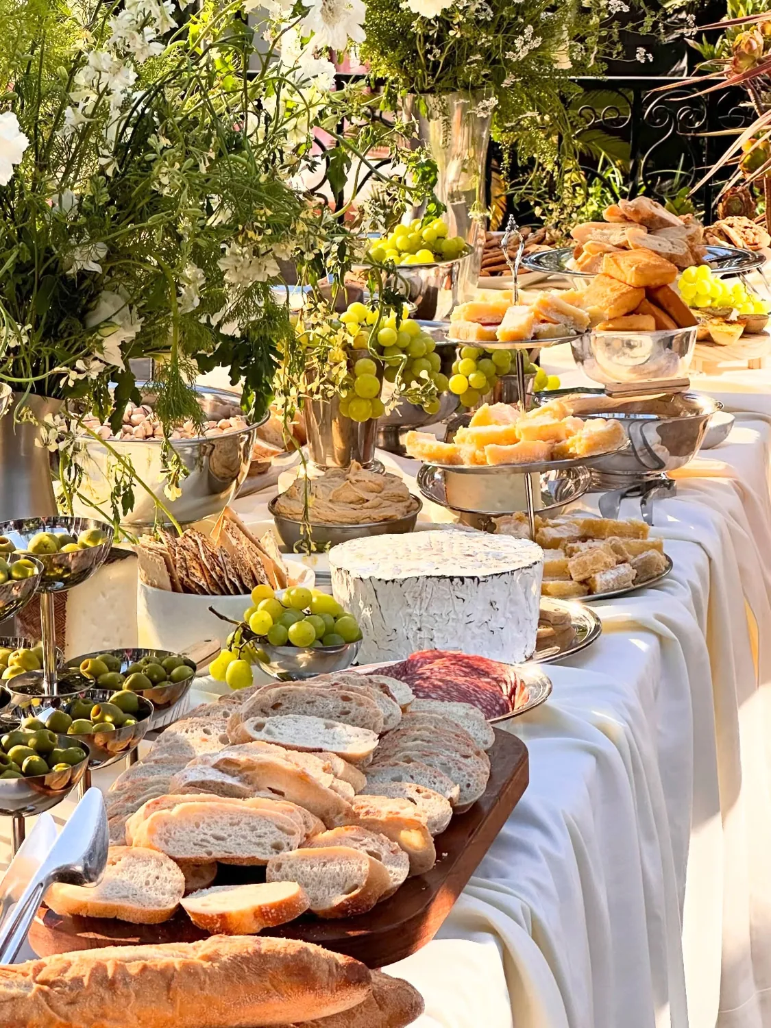 An abundant grazing table of cheeses, meats, and mezze