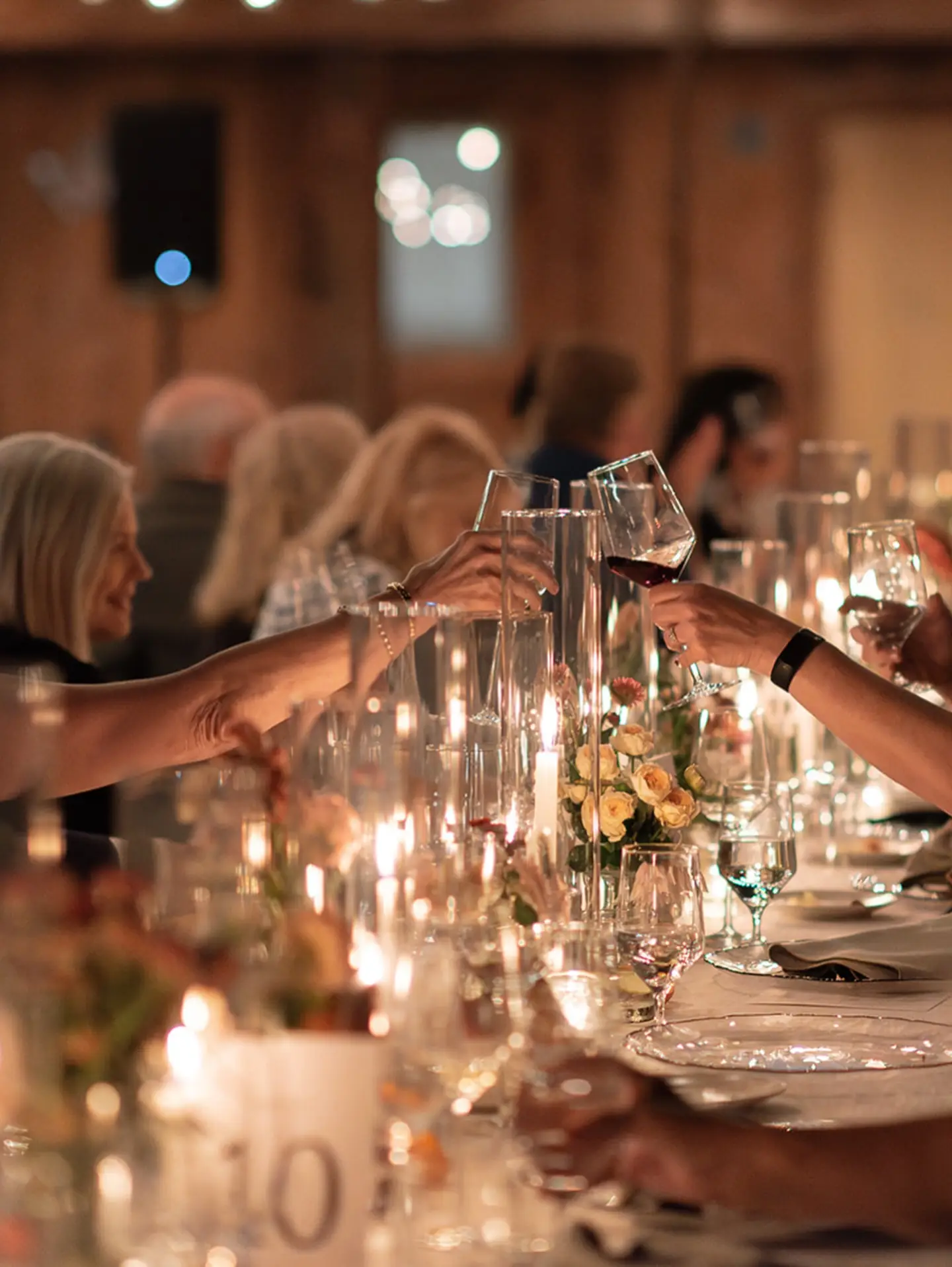 Guests toasting over a candlelit dinner table at Lavender Oak Vineyard