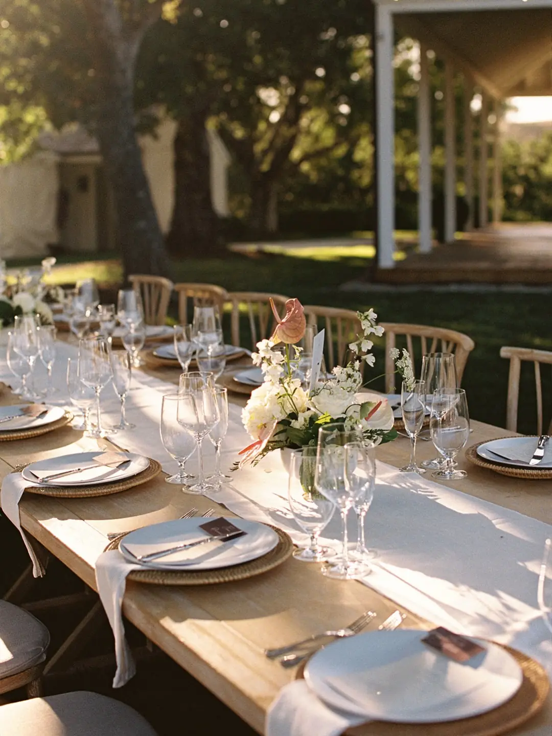 A long table set with glassware and florals at Piocho Ranch