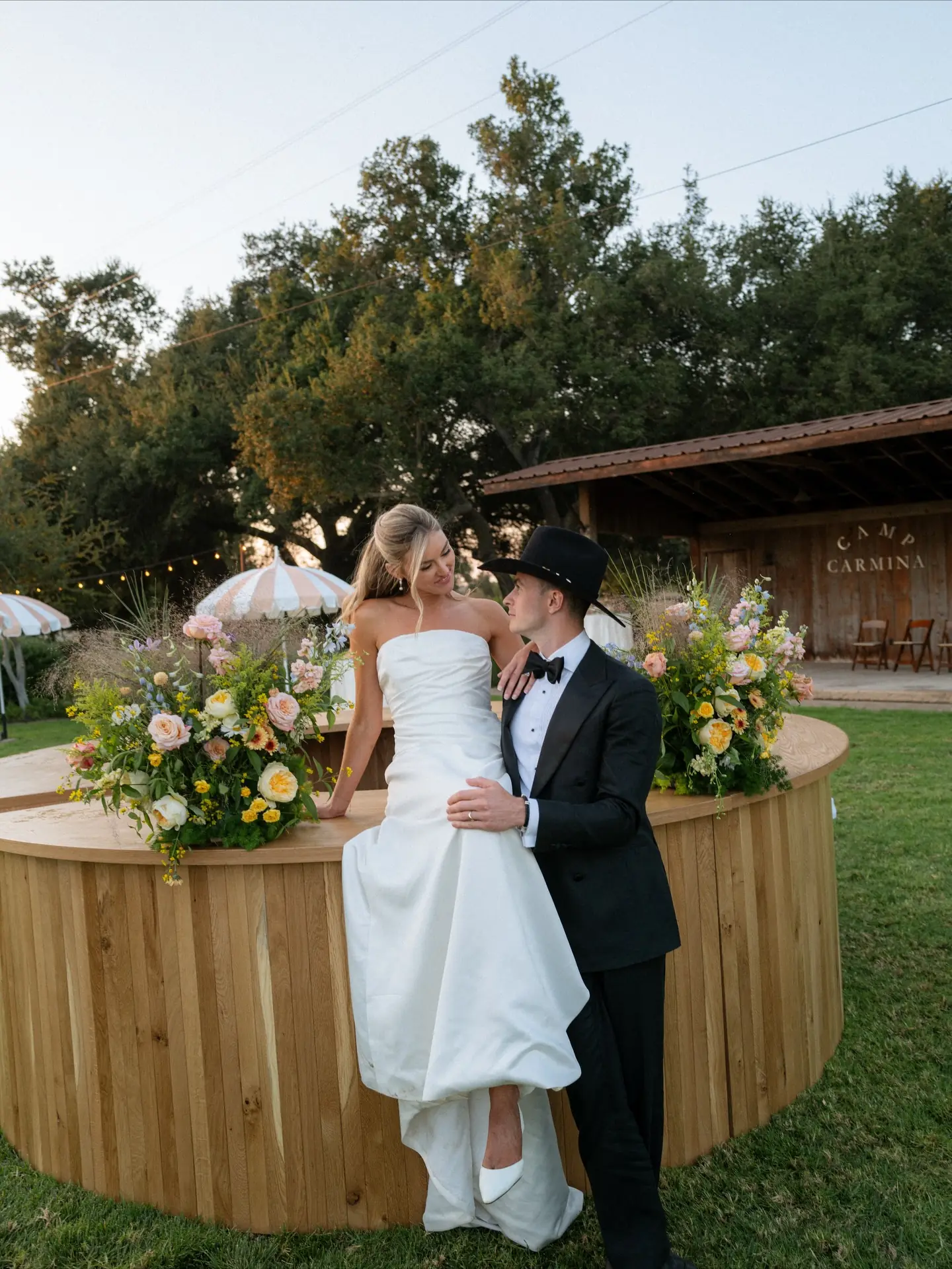 A couple by the bar at Rancho Carmina, the ranch signage behind them
