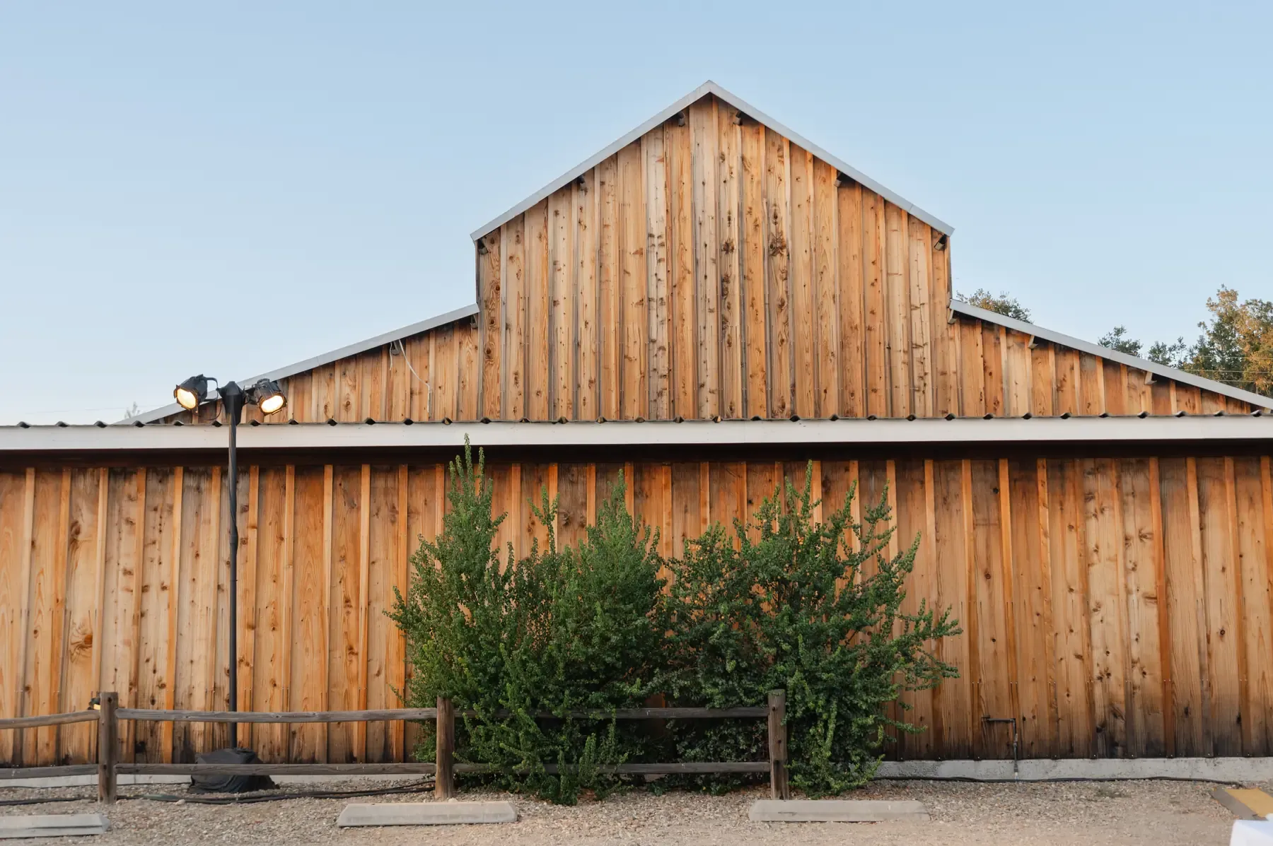 The barn at Rancho Carmina at golden hour, board-and-batten under a stepped gable