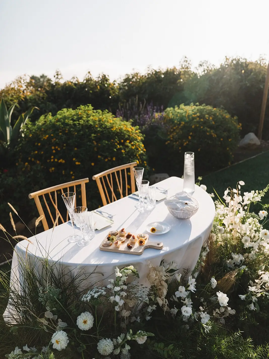 A sweetheart table set with appetizers and florals at Regina Ranch