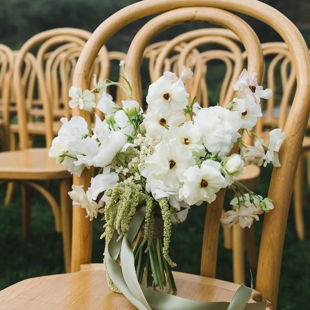 A white bouquet resting on a chair at Regina Ranch