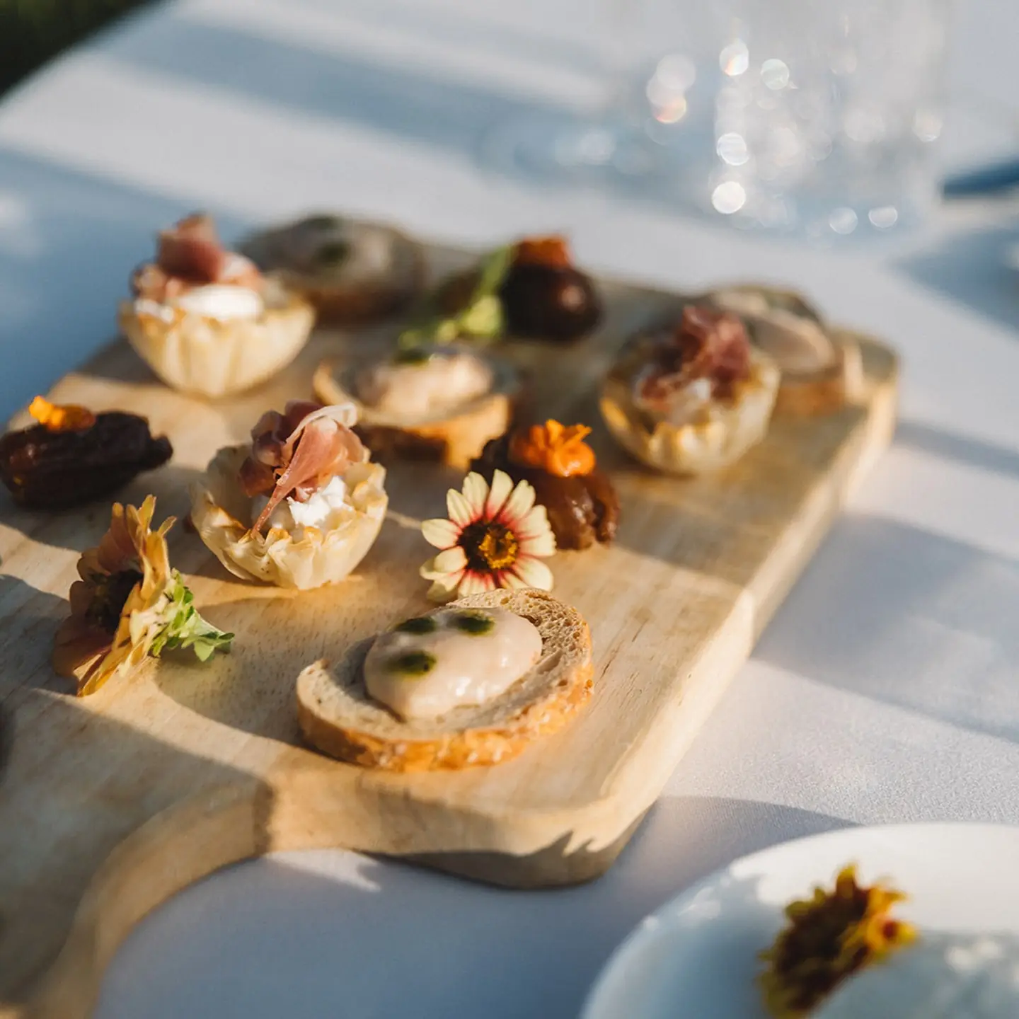Canapés and stuffed dates on a wooden board at Regina Ranch