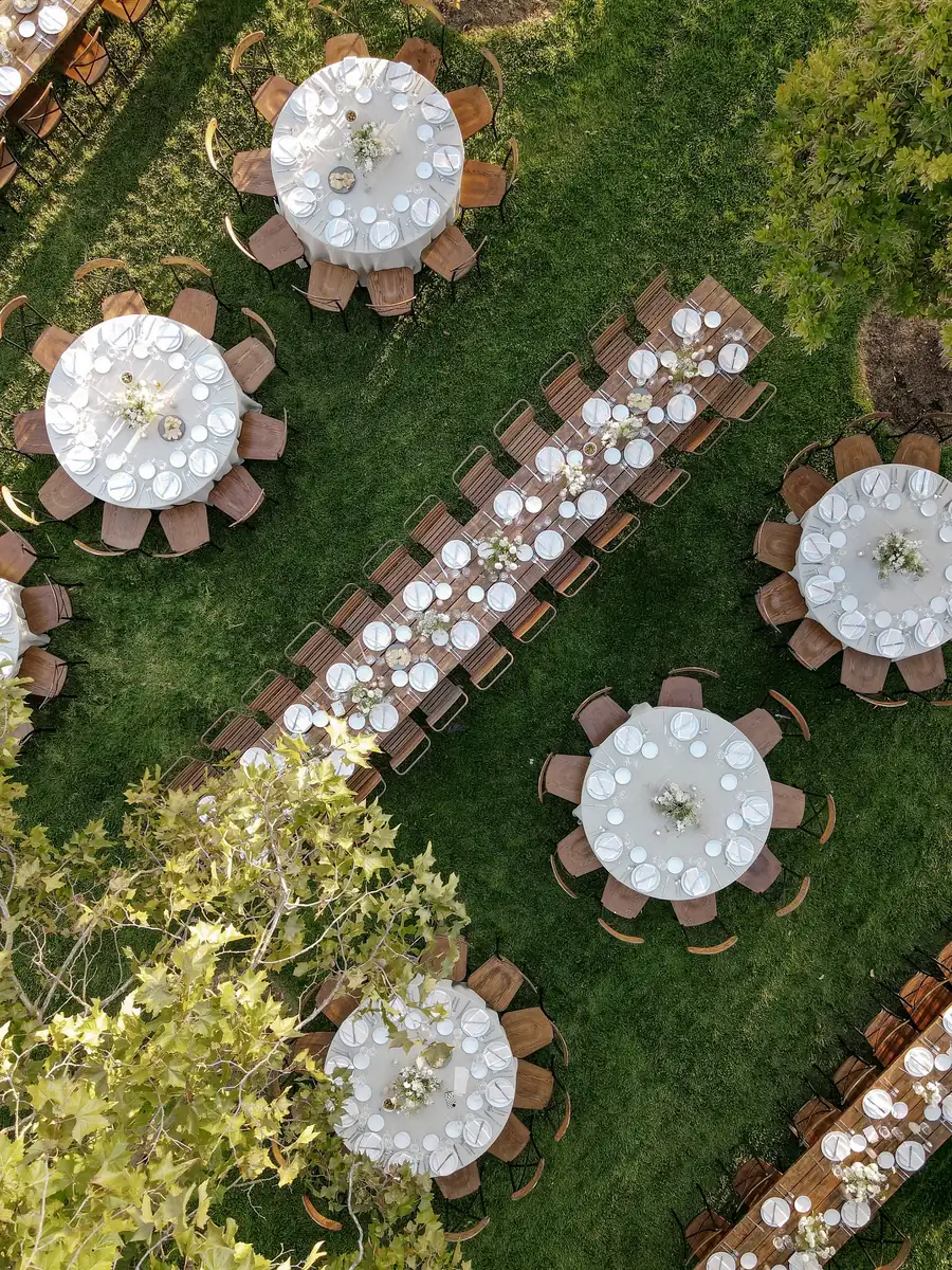 Long tables and rounds set on the lawn at Santa Ynez Ranch, from above