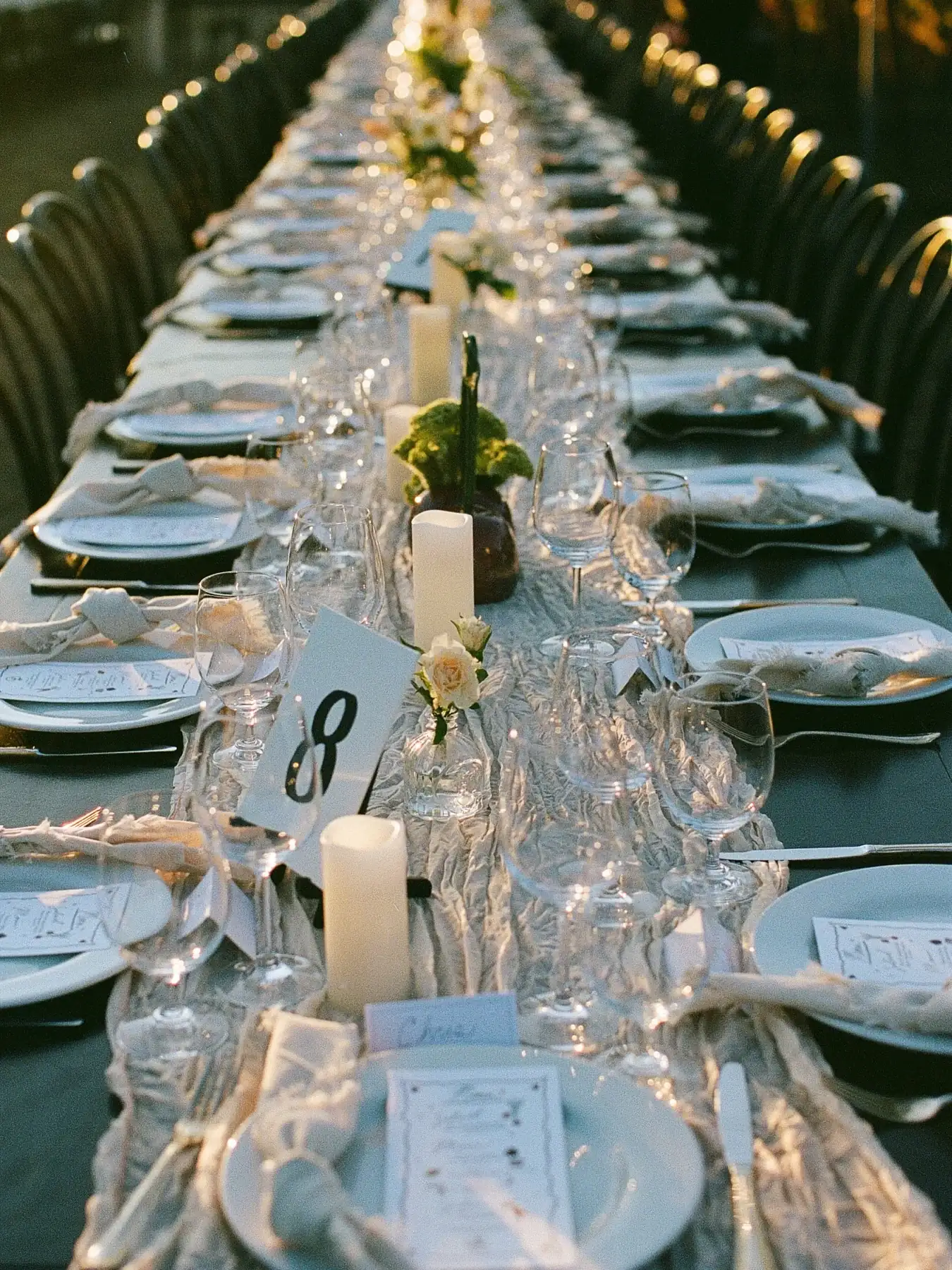 Candles, glassware and a gauzy runner down the length of a long table at Stolo Vineyards
