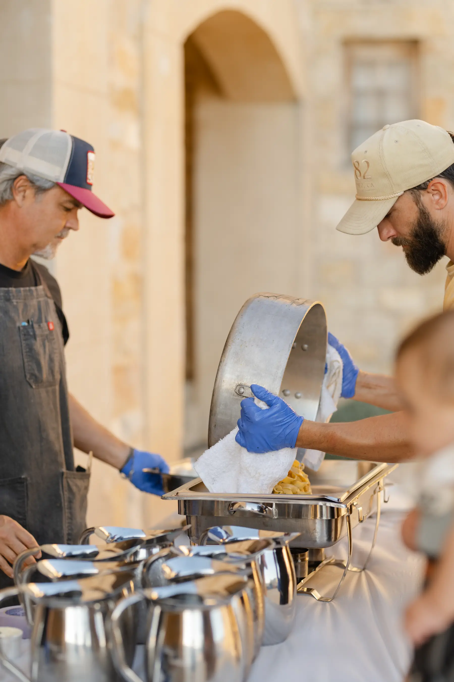 Fresh pasta lifted into a chafing dish beneath the stone archway at Sunstone Villa