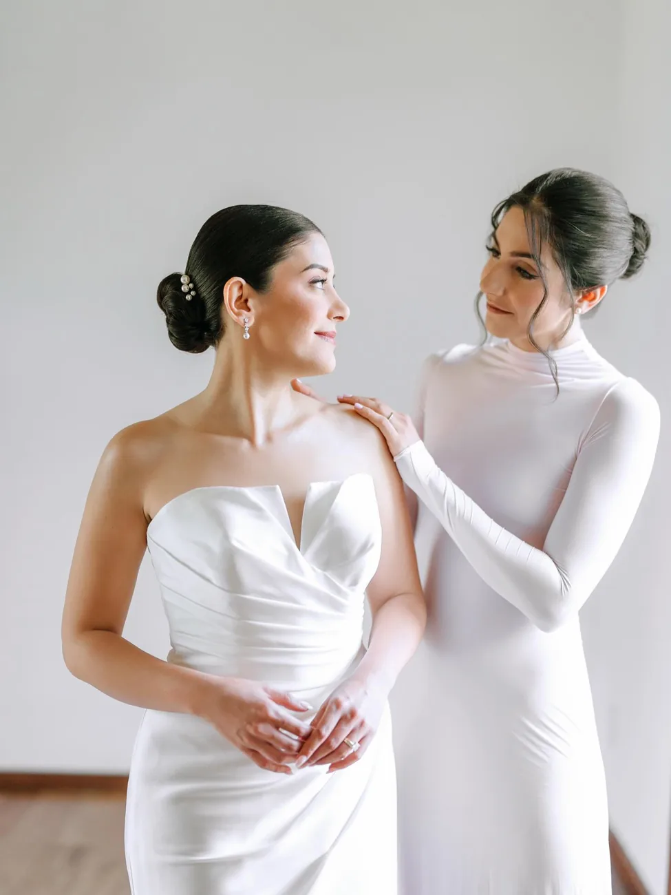 Two brides in elegant white at their wedding