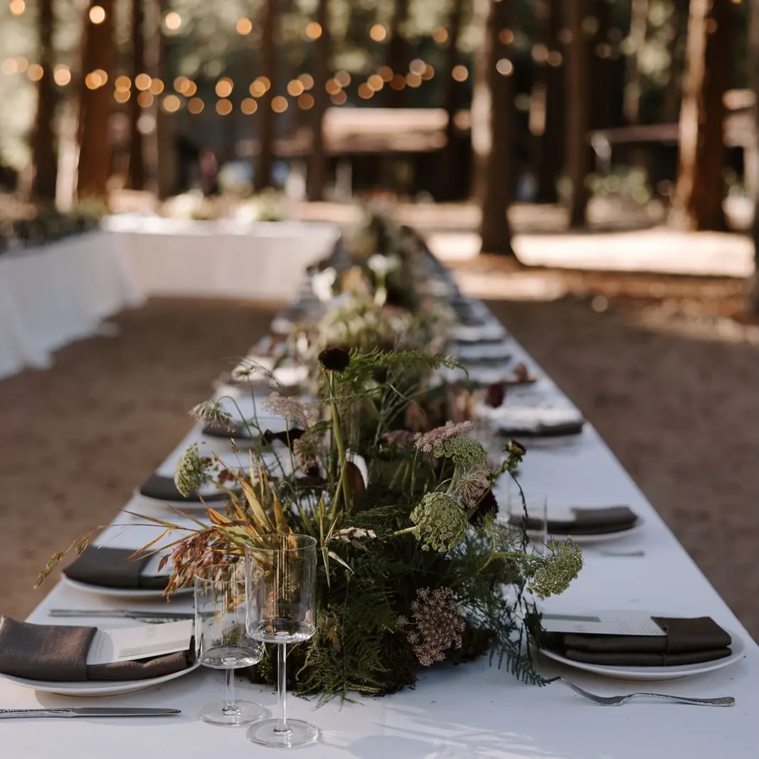 A long table set with greenery and candles at Zaca Lake