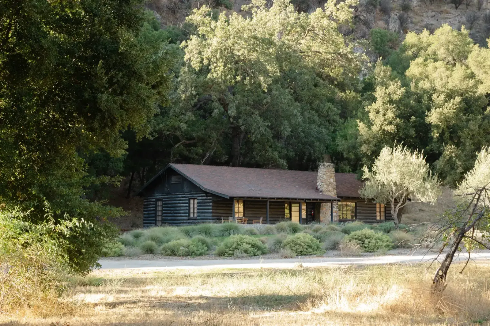 The log lodge with its stone chimney under the oaks at Zaca Lake